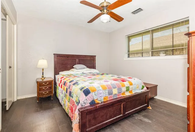 a bed sitting in a bedroom next to a window