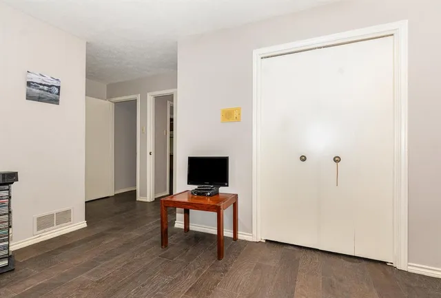 a view of a workspace with furniture and wooden floor