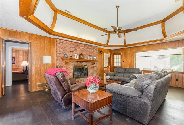 a living room with furniture a chandelier and a window