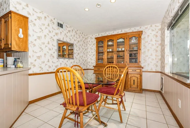 a view of a dining room with furniture and a window