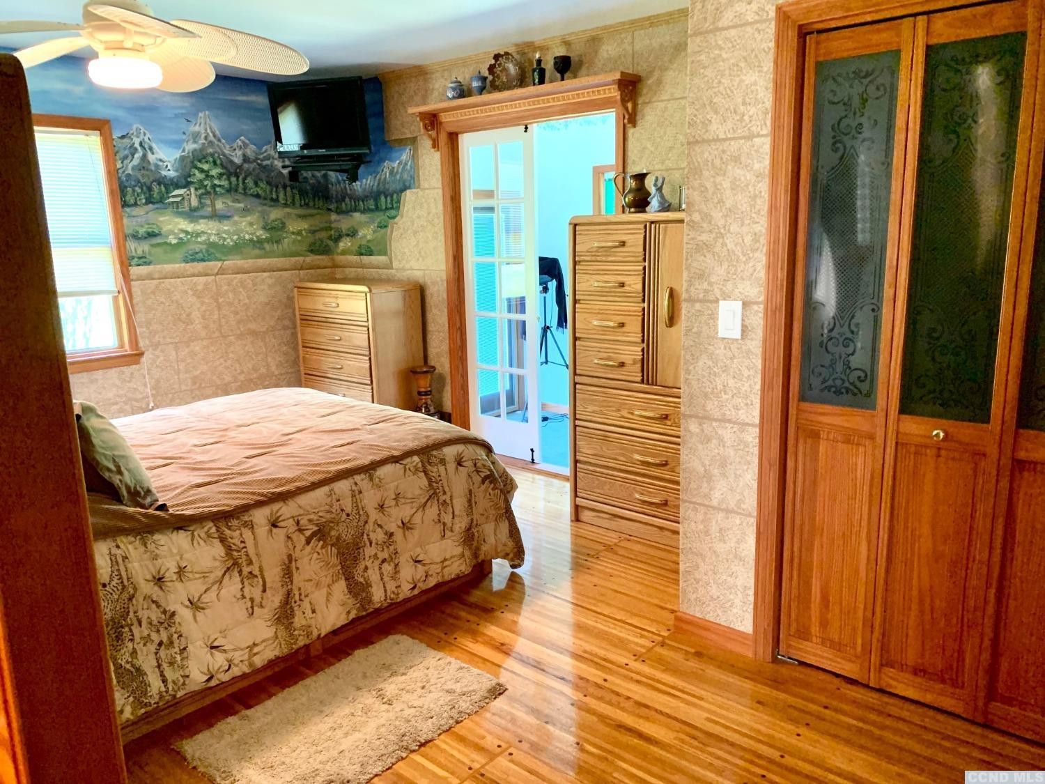 160 Willowbrook Road Hudson, NY 12534 - Photo 11 of 48 a bedroom with a bed and wooden floor