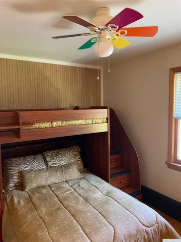 a bedroom with a bed and a dresser