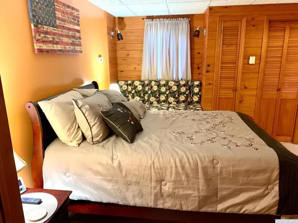 a bedroom with a bed and a window