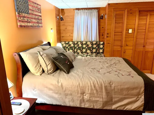 a bedroom with a bed and a window