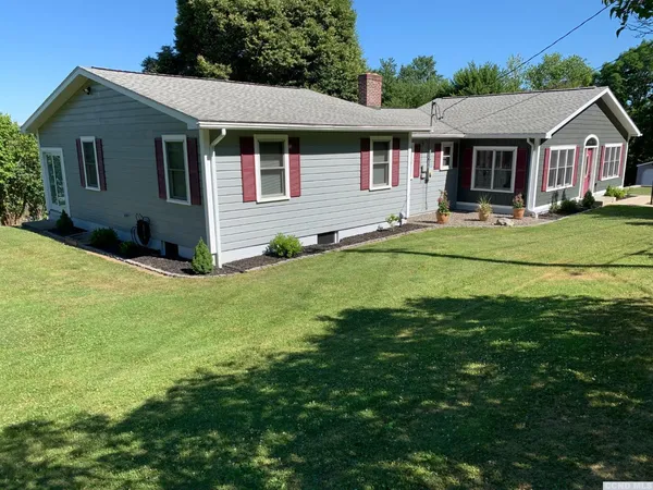 a front view of a house with a yard