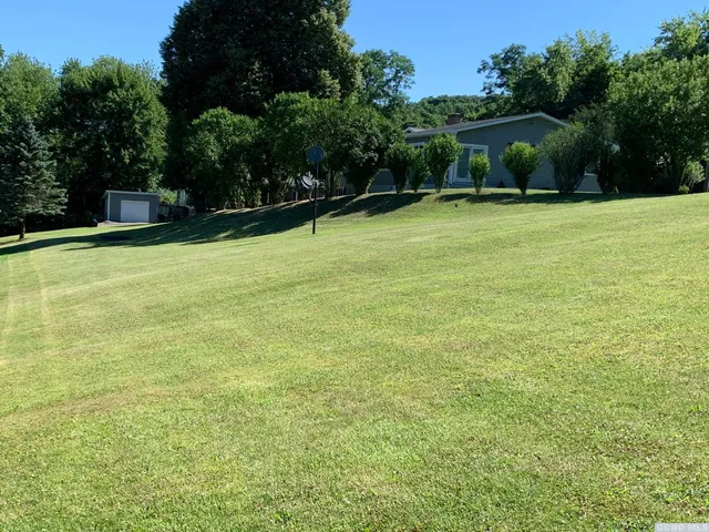 a swimming pool with trees in the background