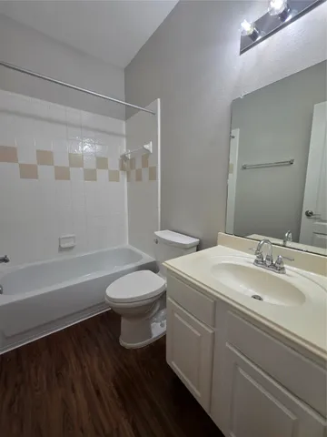 a bathroom with a sink a toilet and a bathtub