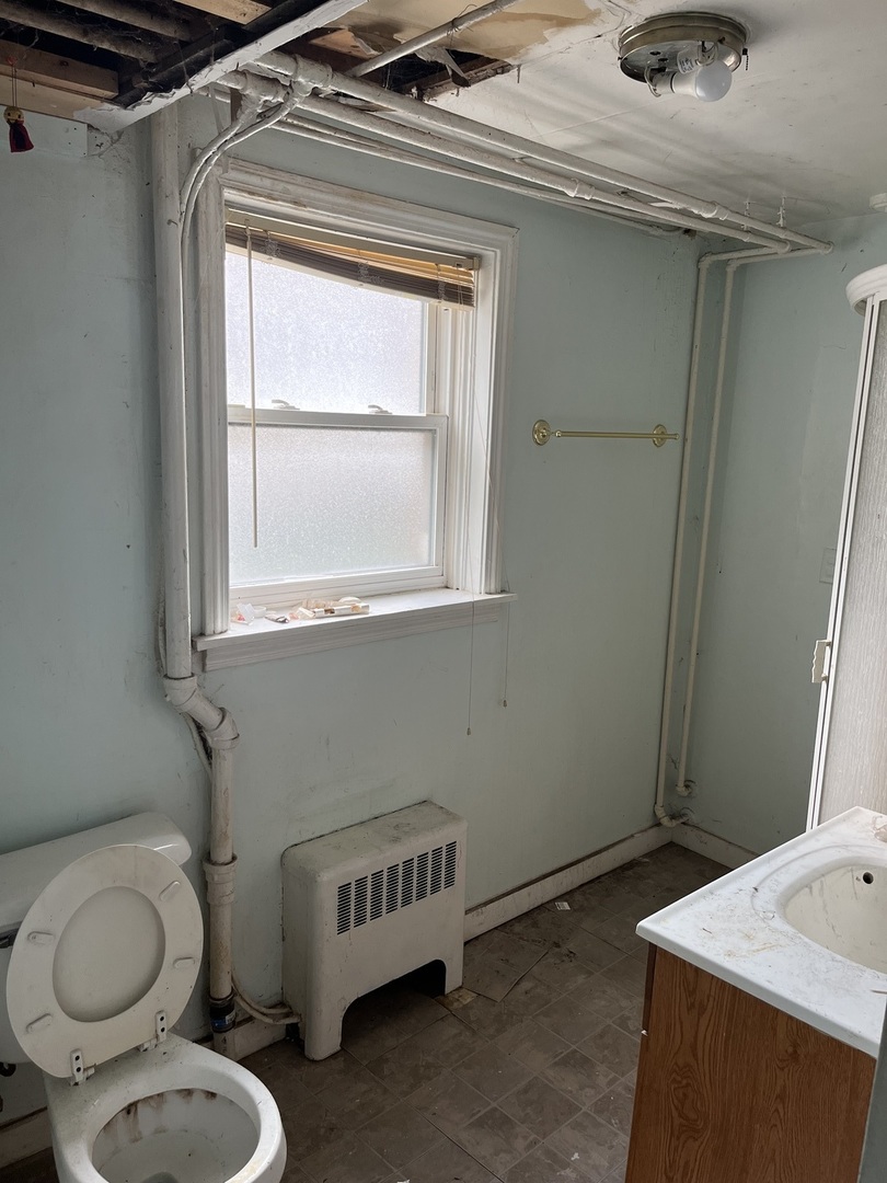 7907 46th Street Lyons, IL 60534 - Photo 11 of 17 a bathroom with a toilet and a sink