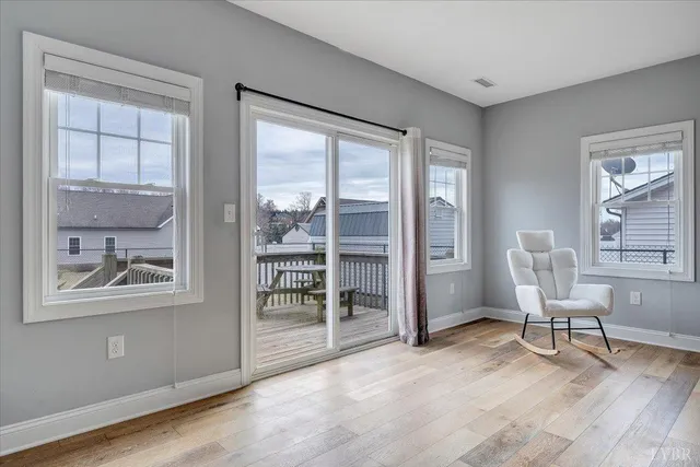 a view of a room with wooden floor windows and a chandelier