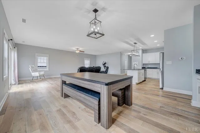 a kitchen with stainless steel appliances granite countertop a refrigerator and a stove top oven
