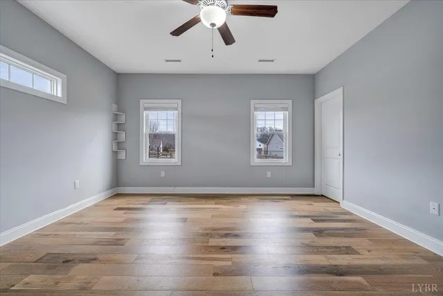 wooden floor in an empty room with a window