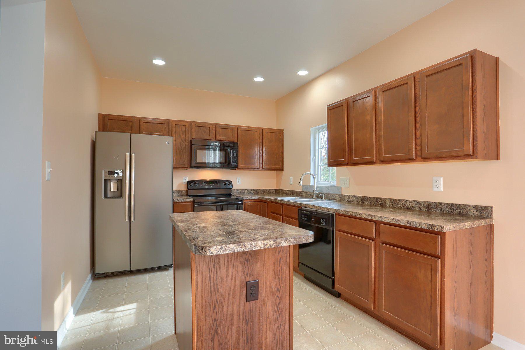 2465 Walnut Bottom Road, Unit 80 York, PA 17408 - Photo 18 of 36 a kitchen with stainless steel appliances granite countertop wooden cabinets a sink and a stove