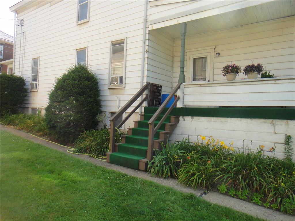 145 Main Street New Eagle, PA 15067 - Photo 22 of 24 a front view of a house with a yard
