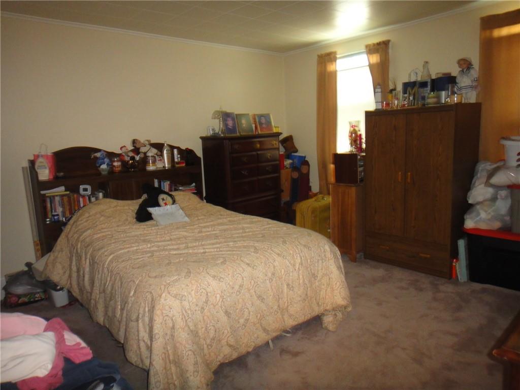 145 Main Street New Eagle, PA 15067 - Photo 5 of 24 a bed sitting in a bedroom next to a window