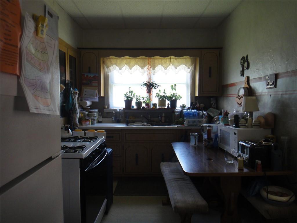 145 Main Street New Eagle, PA 15067 - Photo 10 of 24 a kitchen with a table chairs and a stove