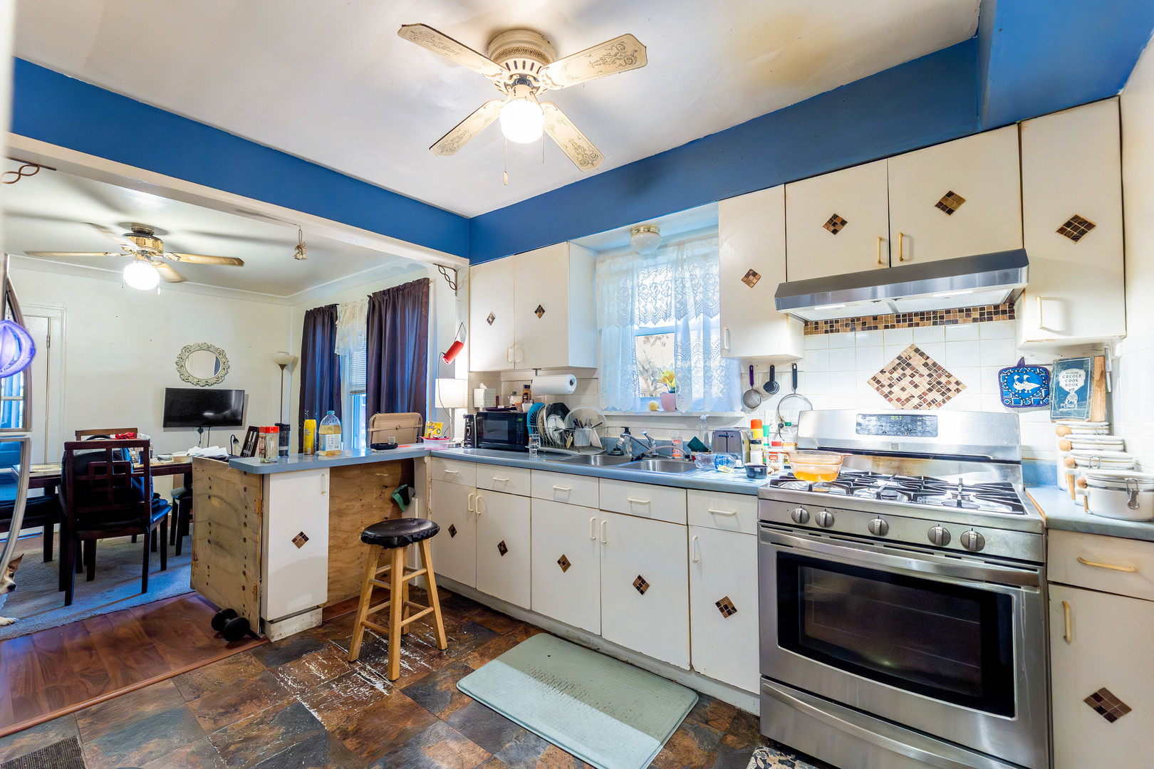 8129 South Cornell Avenue Chicago, IL 60617 - Photo 11 of 21 a kitchen with granite countertop a stove a sink and a refrigerator