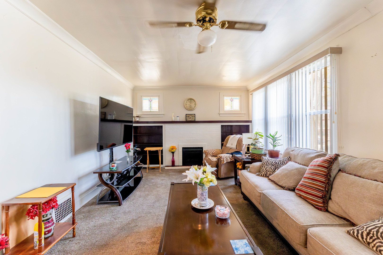 8129 South Cornell Avenue Chicago, IL 60617 - Photo 7 of 21 a living room with furniture and a fireplace