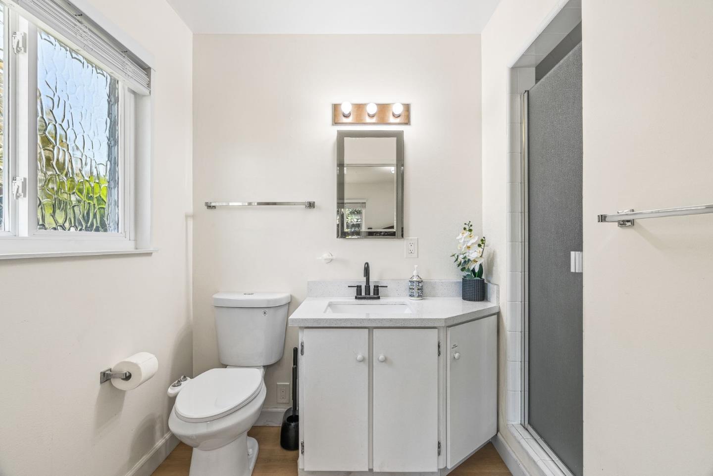 26372 Riverside Place Carmel, CA 93923 - Photo 19 of 35 a bathroom with a toilet sink and mirror
