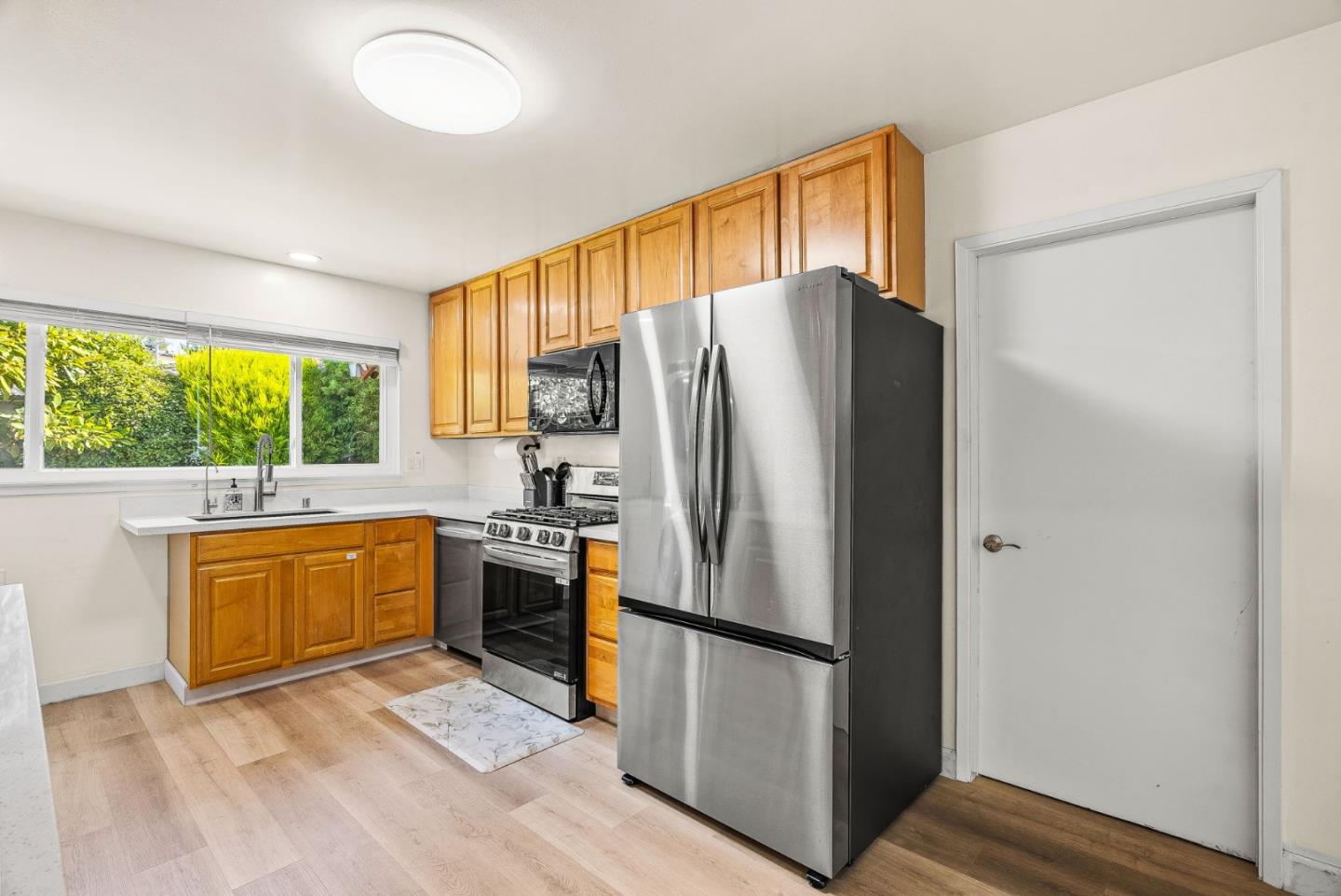 26372 Riverside Place Carmel, CA 93923 - Photo 9 of 35 a kitchen with stainless steel appliances a refrigerator sink and cabinets