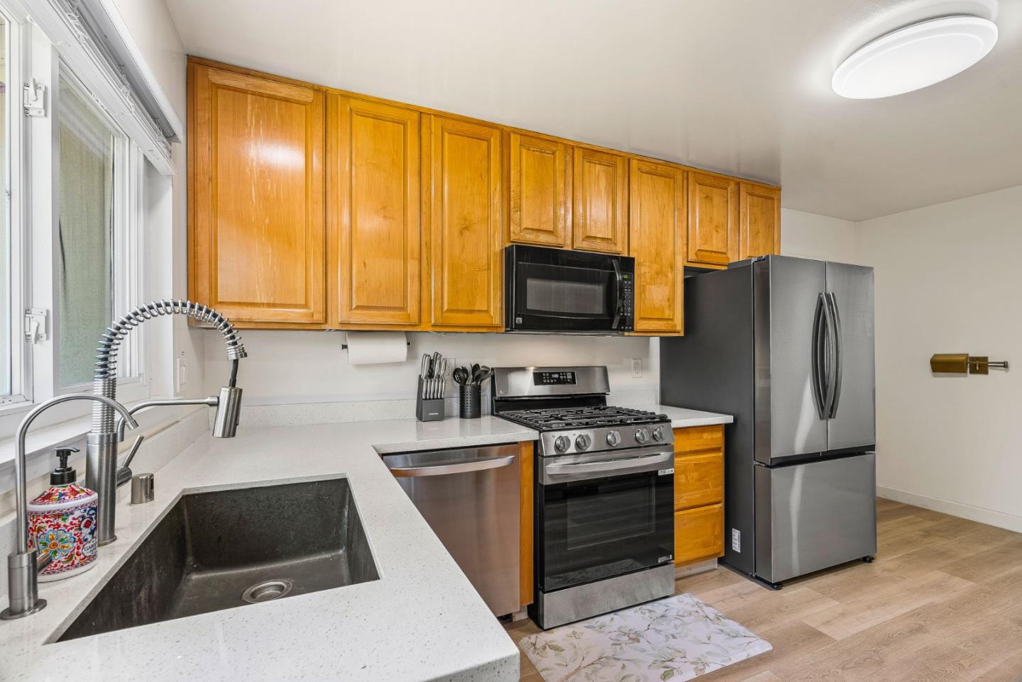 26372 Riverside Place Carmel, CA 93923 - Photo 10 of 35 a kitchen with granite countertop a stove a sink a refrigerator and a microwave