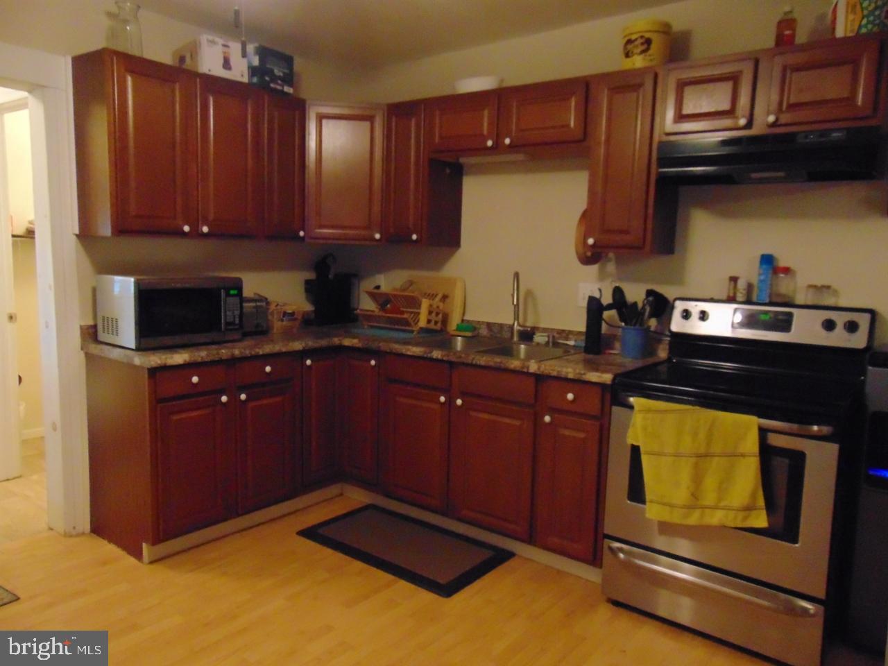 21 West Smith Street Topton, PA 19562 - Photo 18 of 31 a kitchen with granite countertop wooden cabinets and stainless steel appliances