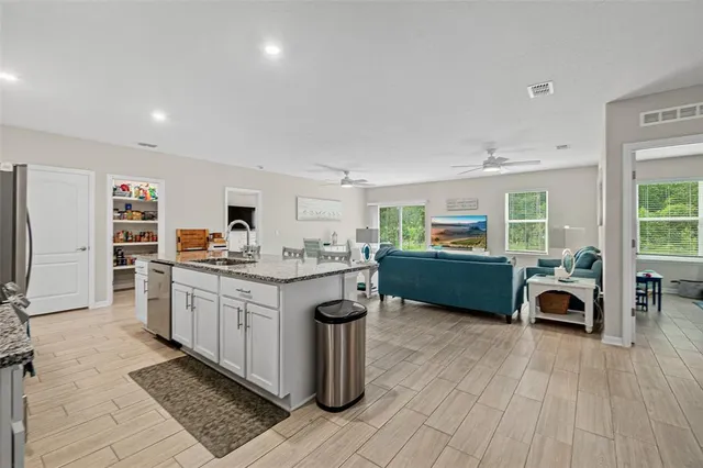 a kitchen with stainless steel appliances granite countertop a sink and cabinets