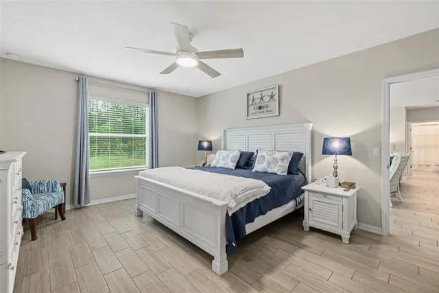 a spacious bedroom with a bed and a window