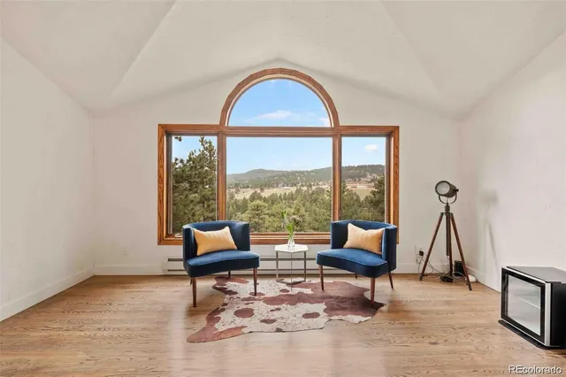a living room with furniture and a floor to ceiling window