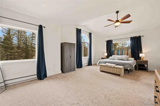 a bedroom with a large bed and a large window