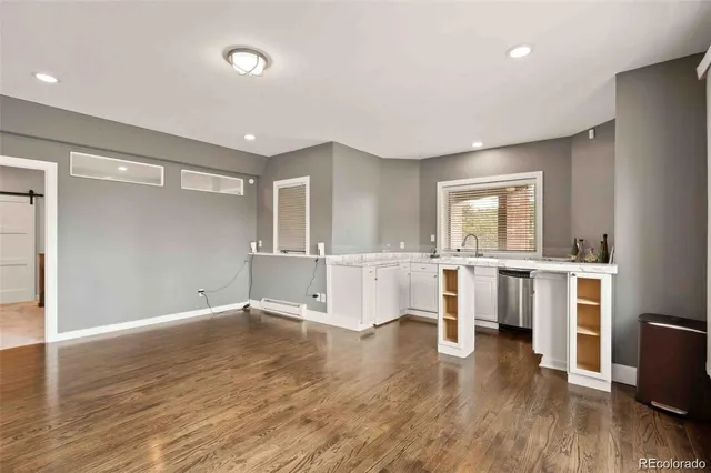 a view of a kitchen with wooden floor