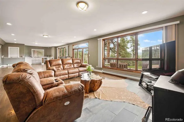 a living room with furniture and large windows