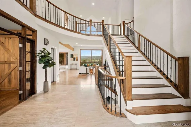 a view of entryway and hall with wooden floor