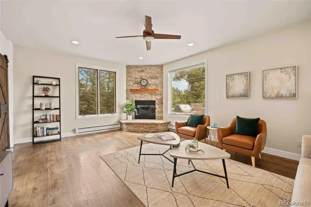 a living room with furniture and large windows