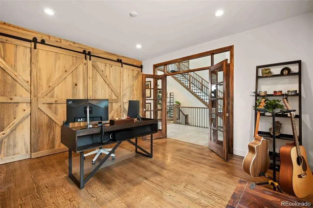 a view of a workspace with wooden floor and a window