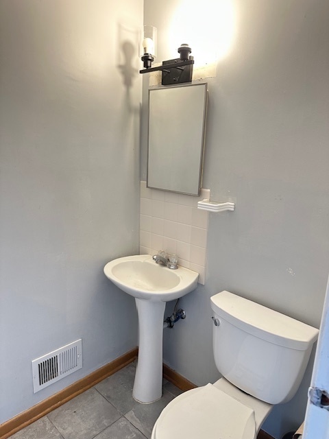 8849 North Wisner Street, Unit 1 Niles, IL 60714 - Photo 12 of 15 a bathroom with a toilet sink and mirror