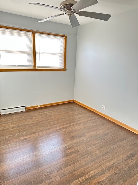 8849 North Wisner Street, Unit 1 Niles, IL 60714 - Photo 13 of 15 an empty room with wooden floor and windows