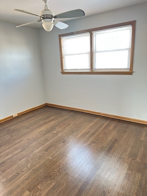 8849 North Wisner Street, Unit 1 Niles, IL 60714 - Photo 15 of 15 an empty room with wooden floor fan and windows