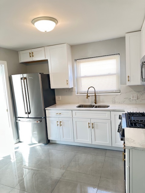8849 North Wisner Street, Unit 1 Niles, IL 60714 - Photo 2 of 15 a kitchen with a sink a refrigerator and cabinets