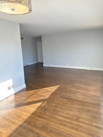 a view of a room with wooden floor and sink