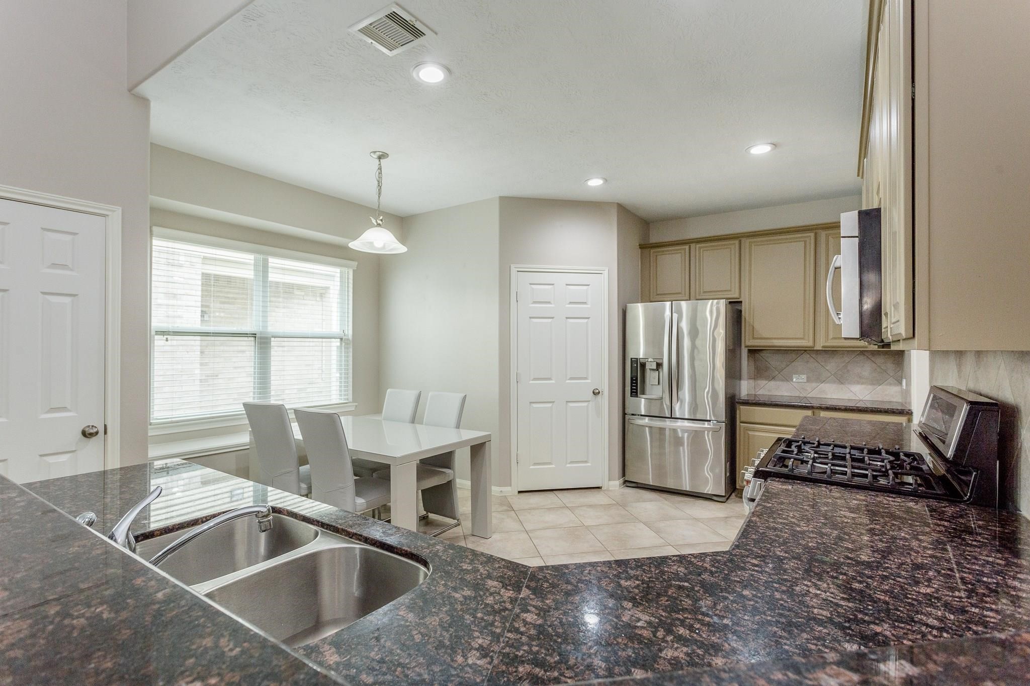 3430 Lilac Ranch Drive Katy, TX 77494 - Photo 12 of 29 a kitchen with stainless steel appliances granite countertop a refrigerator and a sink