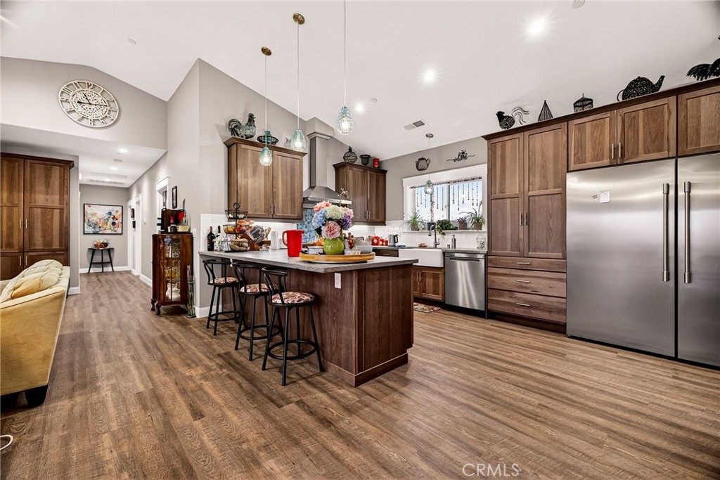 603 Zink Road Berry Creek, CA 95916 - Photo 16 of 69 a kitchen with stainless steel appliances kitchen island granite countertop a refrigerator and a stove top oven