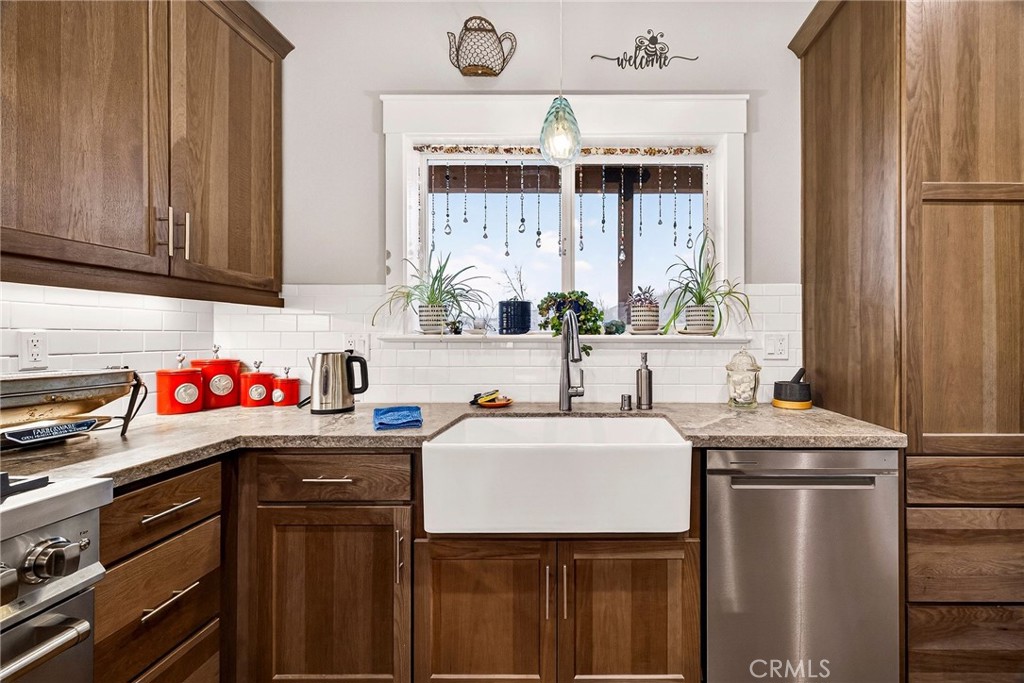 603 Zink Road Berry Creek, CA 95916 - Photo 21 of 69 a utility room with stainless steel appliances a sink window and cabinets