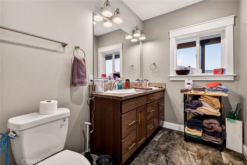603 Zink Road Berry Creek, CA 95916 - Photo 31 of 69 a bathroom with a toilet sink and mirror