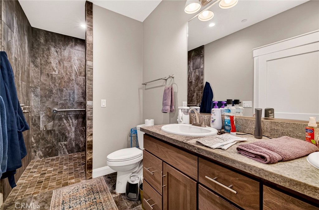 603 Zink Road Berry Creek, CA 95916 - Photo 32 of 69 a bathroom with a granite countertop sink toilet and shower