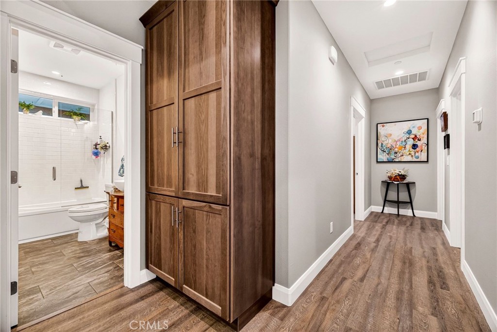 603 Zink Road Berry Creek, CA 95916 - Photo 37 of 69 a view of a hallway with wooden floor and a bathroom