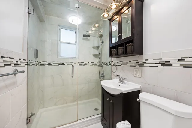 a bathroom with a sink a toilet and mirror