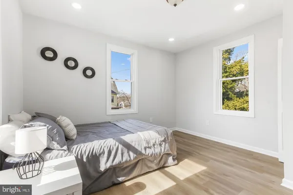 a bedroom with bed and wooden floor