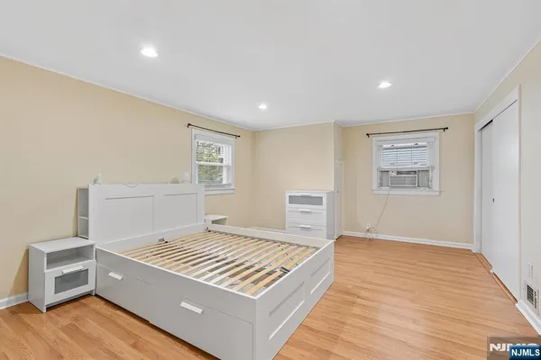 a living room with a bed furniture and a window