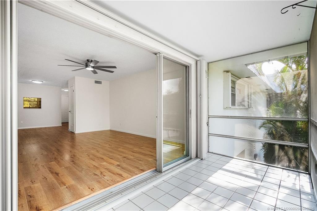2929 Southeast Ocean Boulevard, Unit 1087 Stuart, FL 34996 - Photo 11 of 21 a view of empty room with wooden floor and fan
