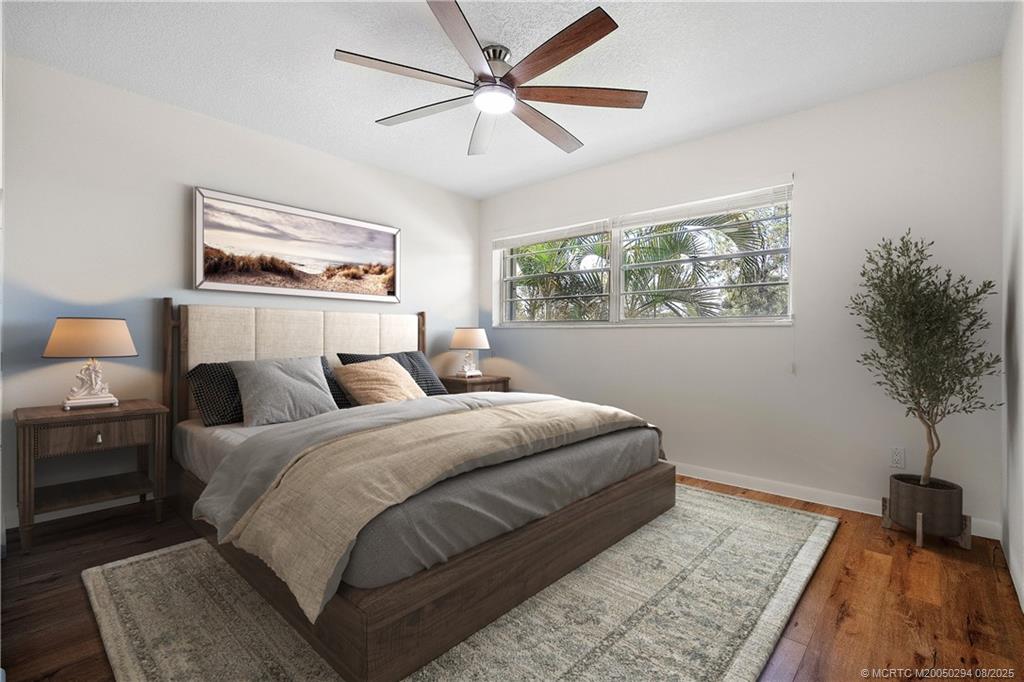 2929 Southeast Ocean Boulevard, Unit 1087 Stuart, FL 34996 - Photo 13 of 21 a bedroom with bed and a potted plant